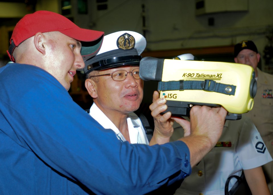 US Navy 100804-N-9950J-070 Damage Controlman Fireman Daniel Marks shows a naval firefighting thermal imager to Chief Petty Officer Shuuji Ochiai during a tour aboard USS Essex (LHD 2)