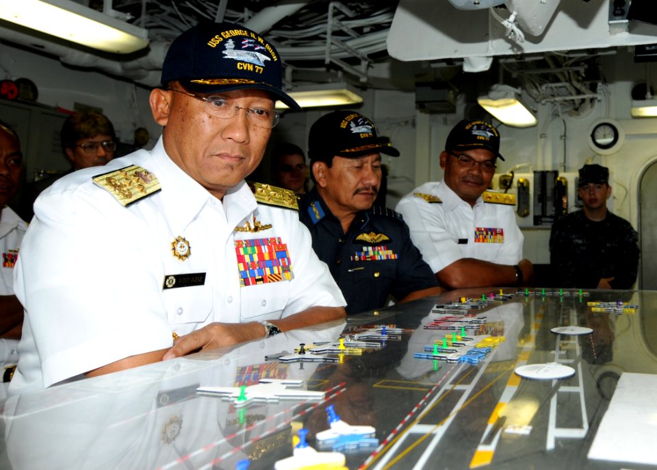 US Navy 100802-N-6632S-130 Adm. Tan Sri Abdul Aziz Jaafar and other officials look at a ouija board in flight deck control during a tour aboard USS George H.W. Bush (CVN 77)