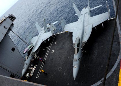 US Navy 100807-N-2821G-009 wo F-A-18 Super Hornets are raised on an elevator to the flight deck aboard the aircraft carrier USS Abraham Lincoln (CVN 72) photo