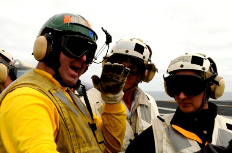 US Navy 100808-N-2918M-179 Lt. Cmdr. Sam Kessler explains the catapult system to a group of distinguished visitors during a tour of USS Nimitz (CVN 68) photo