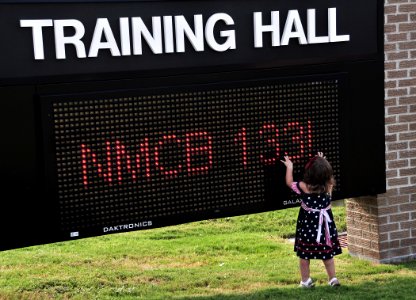 US Navy 100804-N-7367K-003 A child stands near the Training Hall marquee during a homecoming celebration for Naval Mobile Construction Battalion (NMCB) 133 at Naval Construction Battalion Center, Gulfport