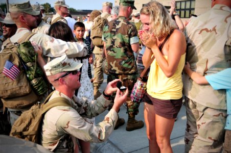 US Navy 100804-N-7367K-005 Equipment Operator Constructionman Apprentice Jon Sanders, assigned to Naval Mobile Construction Battalion (NMCB) 133, proposes to his girlfriend during a homecoming celebration photo