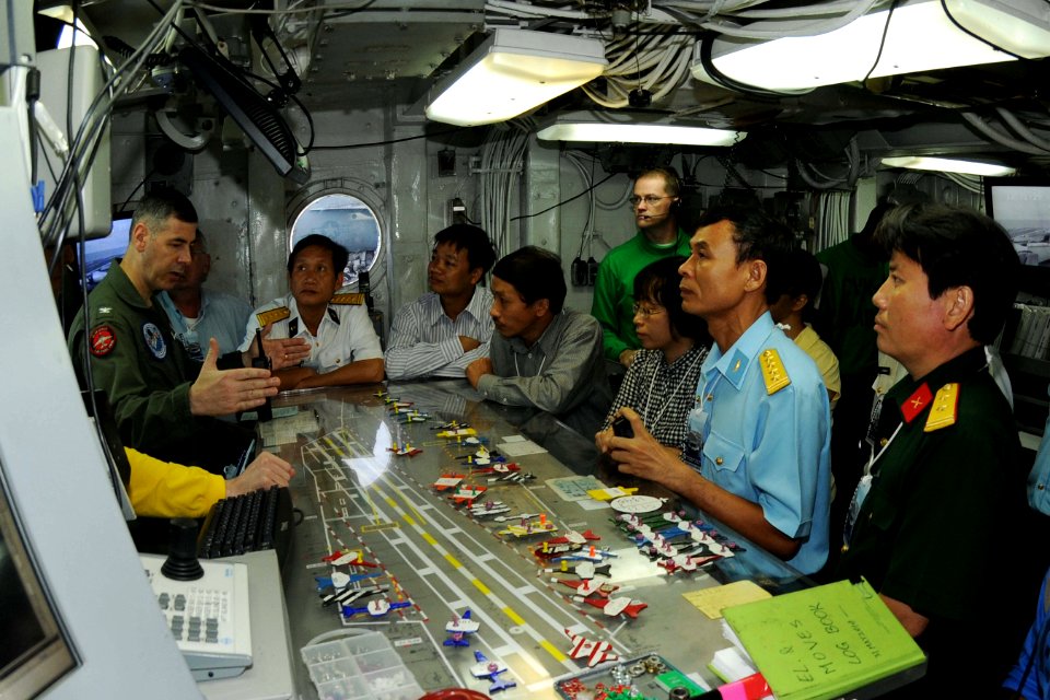 US Navy 100808-N-4830B-033 Capt. Daniel Grieco, left, executive officer of the aircraft carrier USS George Washington (CVN 73), explains flight deck operations to senior military and civilian officials from Vietnam