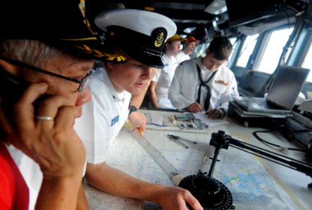US Navy 100804-N-7280V-229 Chief Quartermaster Clint Tergeson, right, and harbor pilot Capt. Ross Sarmientos guide the U.S. 7th Fleet command ship USS Blue Ridge (LCC 19) through the Manila South Harbor