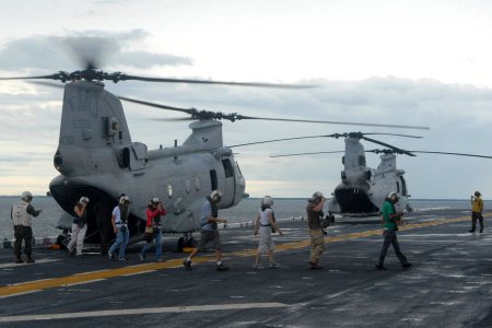 US Navy 100808-N-7680E-017 Non-governmental organization personnel depart a U.S. Marine Corps CH-46E Sea Knight helicopter aboard the amphibious assault ship USS Iwo Jima (LHD 7) during Continuing Promise 2010