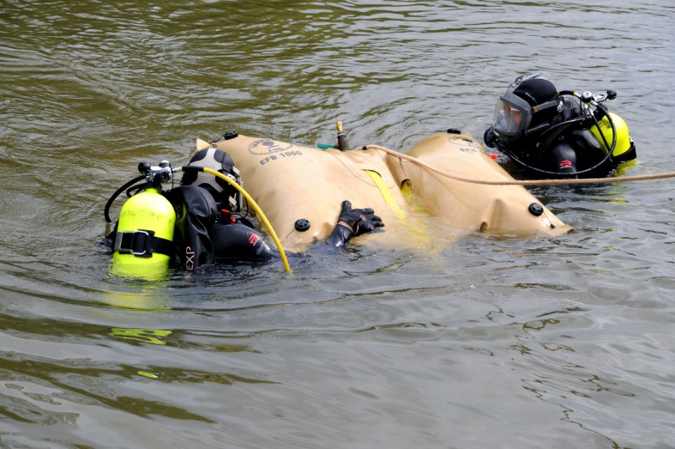US Navy 100804-N-9671T-032 Underwater archeologists George Schwarz, left, and Alexis Catsambis position a lift bag to readjust shoring during the excavation of the U.S. sloop-of-war Scorpion