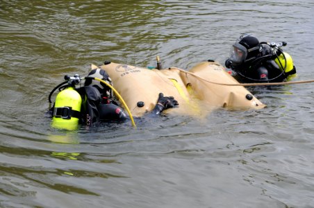 US Navy 100804-N-9671T-032 Underwater archeologists George Schwarz, left, and Alexis Catsambis position a lift bag to readjust shoring during the excavation of the U.S. sloop-of-war Scorpion