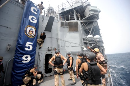 US Navy 100804-N-6463B-109 Sailors assigned to the ship's visit, board, search and seizure team and Coast Guardsmen assigned to Law Enforcement Detachment 404
