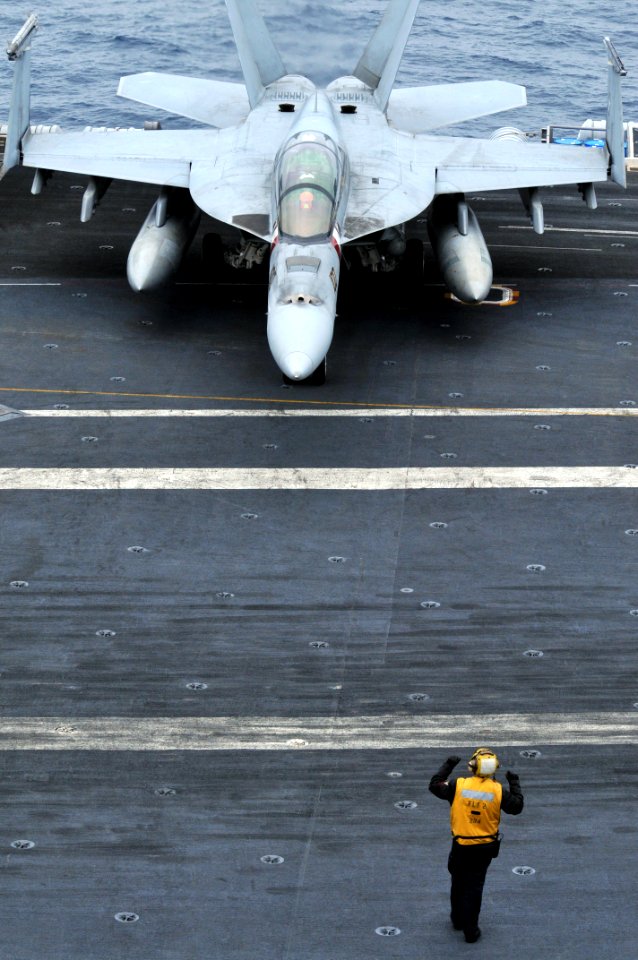 US Navy 100807-N-5749W-196 A Sailor guides Capt. John Eden, piloting an F-A-18F Super Hornet assigned to the Bounty Hunters of Strike Fight Squadron (VFA) 2