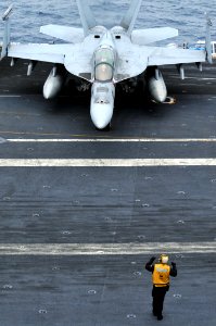 US Navy 100807-N-5749W-196 A Sailor guides Capt. John Eden, piloting an F-A-18F Super Hornet assigned to the Bounty Hunters of Strike Fight Squadron (VFA) 2