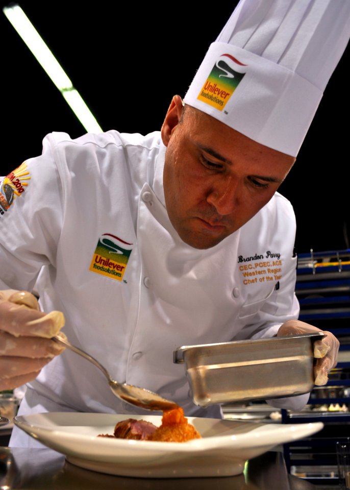 US Navy 100805-N-3069F-001 Chief Culinary Specialist Brandon Parry, assigned to Commander, Naval Air Forces in San Diego, plates his main entree during the American Culinary Federation's Chef of the Year competition