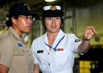 US Navy 100804-N-9950J-051 hief Information Systems Technician Jannett King and Petty Officer 2nd Class Etsuko Nakamura observe the well deck of USS Essex (LHD 2)