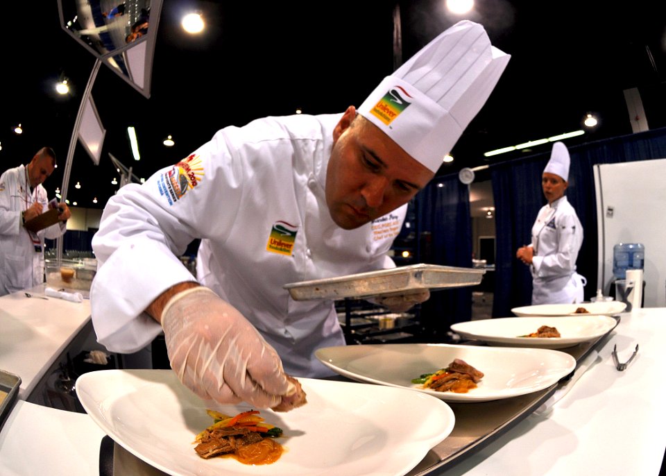 US Navy 100805-N-3069F-002 Chief Culinary Specialist Brandon Parry, assigned to Commander, Naval Air Forces in San Diego, plates his main entree during the American Culinary Federation's Chef of the Year competition