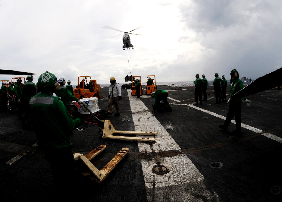 US Navy 100809-N-4830B-028 Supply department Sailors stand by to transport supplies aboard the aircraft carrier USS George Washington (CVN 73)