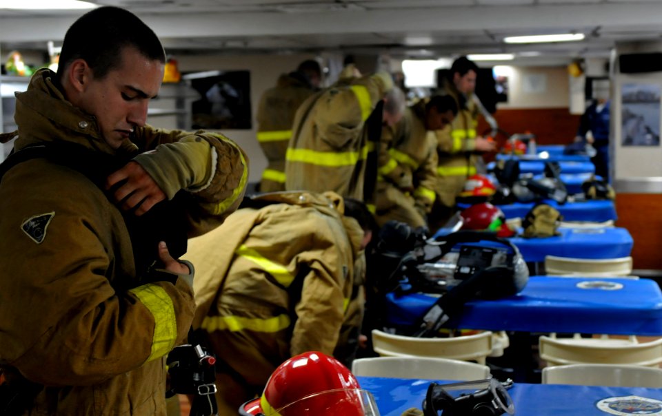 US Navy 100809-N-7280V-119 Damage Controlman Fireman Steven Woolums prepares to combat a simulated major fuel oil leak during an engine room fire drill aboard USS Blue Ridge (LCC 19)