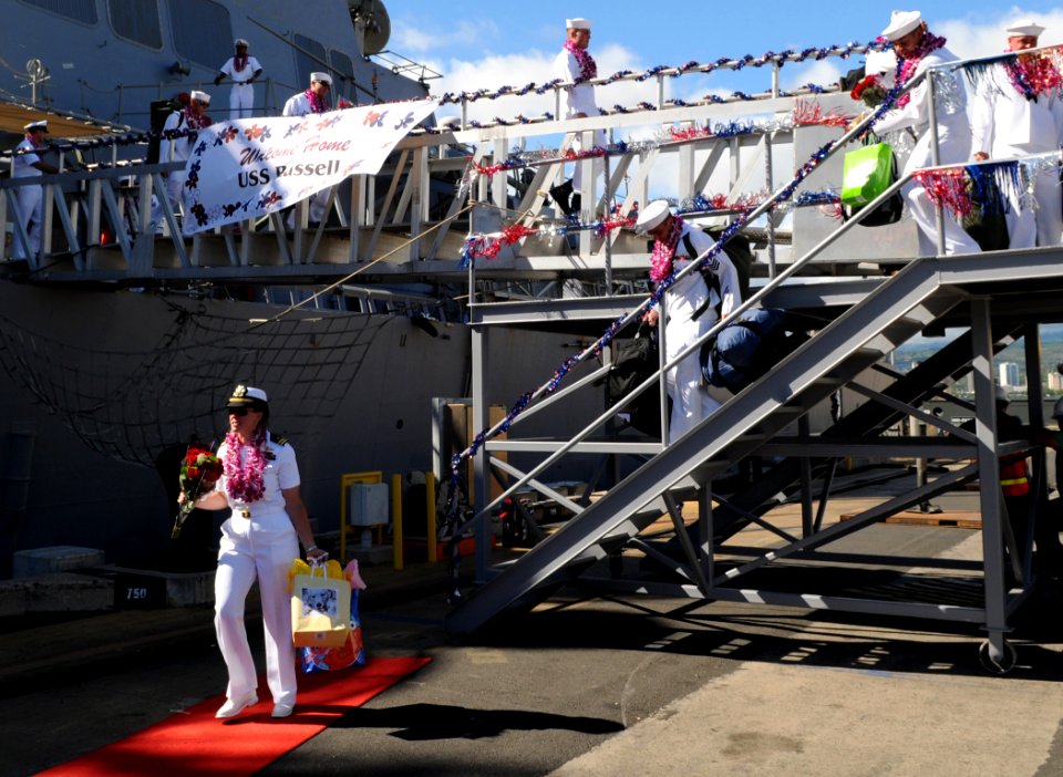 US Navy 100806-N-3666S-085 Sailors walk off the brow of the guided-missile destroyer USS Russell (DDG 59) after returning to Joint Base Pearl Harbor-Hickam from a scheduled seven-month deployment