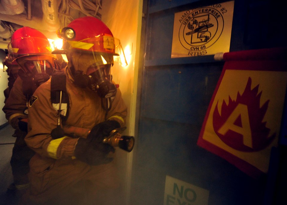 US Navy 100807-N-0569K-049 Members of the repair locker 1F firefighting team aboard the aircraft carrier USS Enterprise (CVN 65) attack a simulated fire
