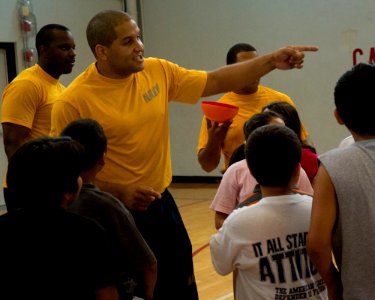 US Navy 100810-N-2389S-029 viation Ordnanceman 2nd Class Javier Keyser organizes kids at a local YMCA during a fitness challenge as part of Chicago Navy Week