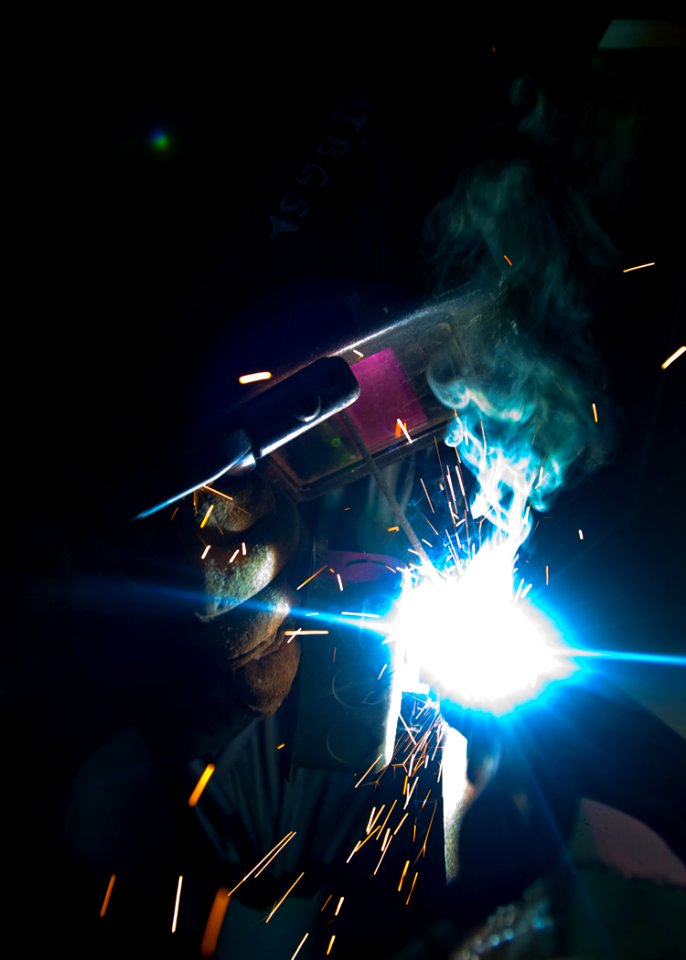 US Navy 100806-N-6720T-005 Hull Maintenance Technician Fireman Zac Vess uses an arc welder to reattach an electrical outlet mounting post to the hull of USS George Washington (CVN 73)