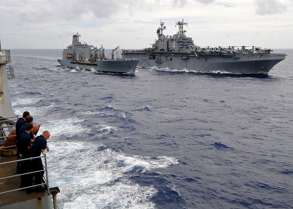 US Navy 100810-N-1082Z-032 Sailors aboard the amphibious dock landing ship USS Ashland (LSD 48) watch the Military Sealift Command fleet replenishment oiler USNS Leroy Grumman (T-AO 194) conduct a replenishment at sea