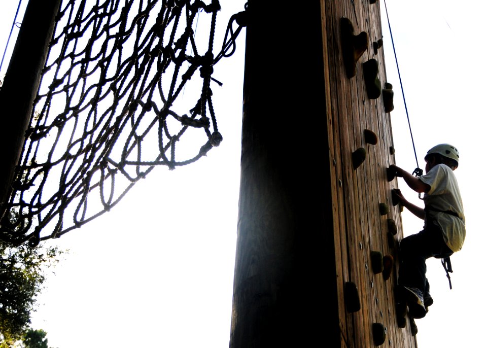 US Navy 100810-N-3013W-014 A Drug Education for Youth (DEFY) summer camp attendee from Naval Air Station Jacksonville climbs a rock wall during a goal setting exercise at Camp McConnell in Micanopy, Fla
