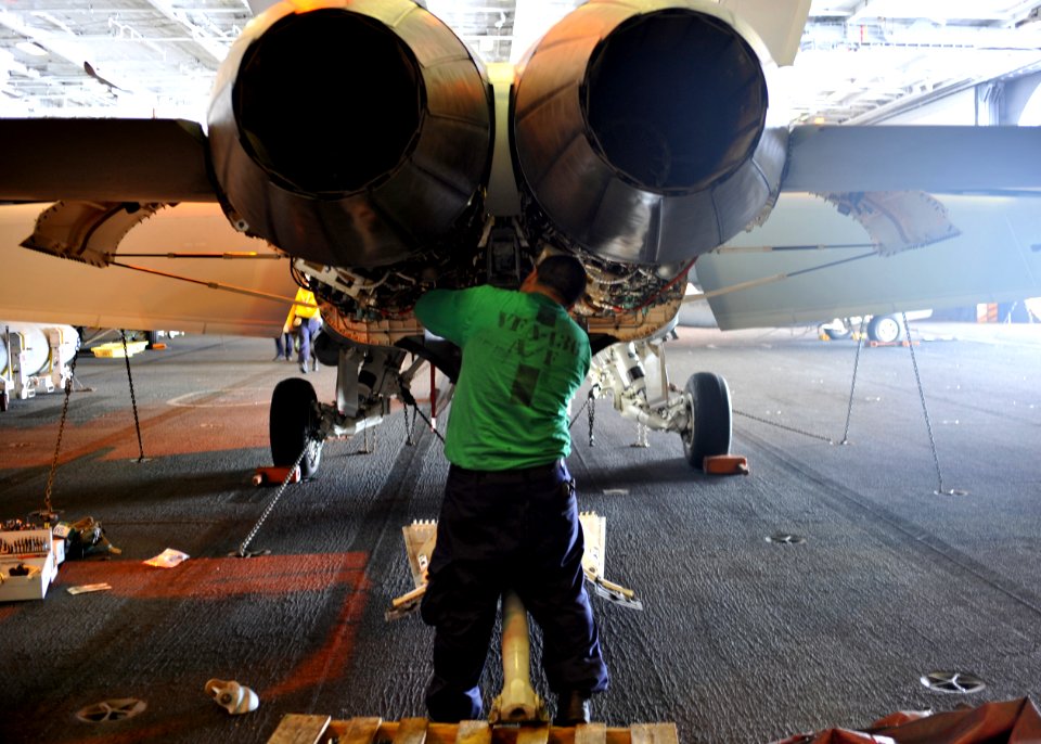 US Navy 100807-N-1287L-062 Aviation Structural Mechanic 1st Class Jose A. Zayas replaces an up-latch assembly for the tailhook of an F-A-18F Super Horne