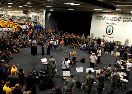US Navy 100809-N-4153W-342 Latin singer Carolina La O and the U.S. Air Force band, Nueva Armonia, entertain Sailors, Soldiers and Marines in the hangar bay of the multipurpose amphibious assault ship USS Iwo Jima (LHD 7)