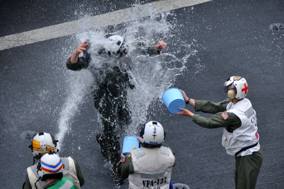 US Navy 100807-N-5749W-666 Capt. Alton E. Ross Jr. receives a soaking down as he returns to the aircraft carrier USS Abraham Lincoln (CVN 72)