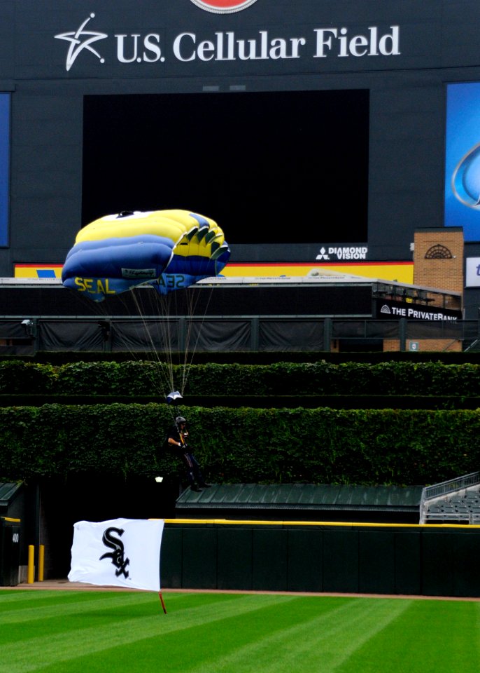 US Navy 100810-N-5366K-167 Chief Special Warfare Operator (SEAL) Justin Gauny, assigned to the U.S. Navy demonstration parachute team, the Leap Frogs, makes his final approach to land with a Chicago White Sox flag