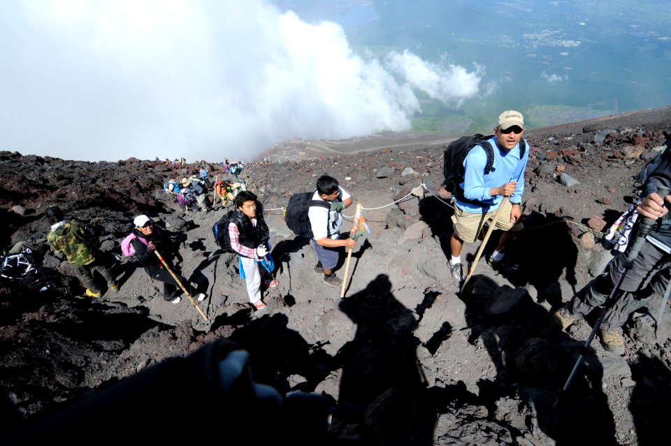 US Navy 100807-N-8335D-868 Lt. Mitch Garcia, from San Juan, Puerto Rico, leads Lt. Gerry Prudencio, from San Diego, and a long trail of climbers up Mount Fuji, during a Fleet Activities Sasebo Sailing and Outdoor Adventure Cen