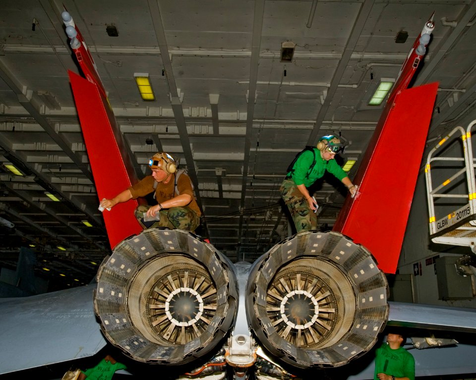 US Navy 100810-N-6720T-007 Sailors apply a corrosion control solvent to the vertical stabilizers of an F-A-18 Super Hornet assigned to the Diamondbacks of Strike Fighter Squadron (VFA) 102 aboard the aircraft carrier USS George