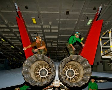 US Navy 100810-N-6720T-007 Sailors apply a corrosion control solvent to the vertical stabilizers of an F-A-18 Super Hornet assigned to the Diamondbacks of Strike Fighter Squadron (VFA) 102 aboard the aircraft carrier USS George