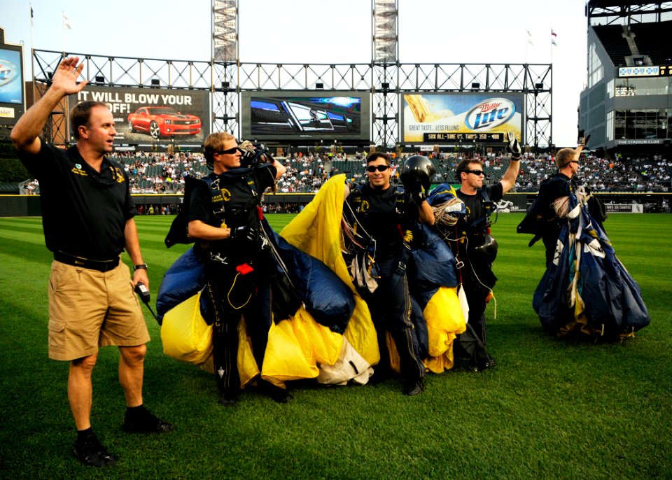 US Navy 100810-N-5366K-254 Members of the U.S. Navy parachute demonstration team, the Leap Frogs, wave to spectators after parachuting during the opening ceremony of a Chicago White Sox baseball game
