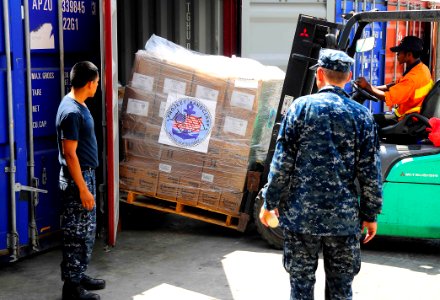 US Navy 100811-N-6410J-148 Sailors ensure safety precautions are exercised as supplies donated by Project Handclasp are offloaded