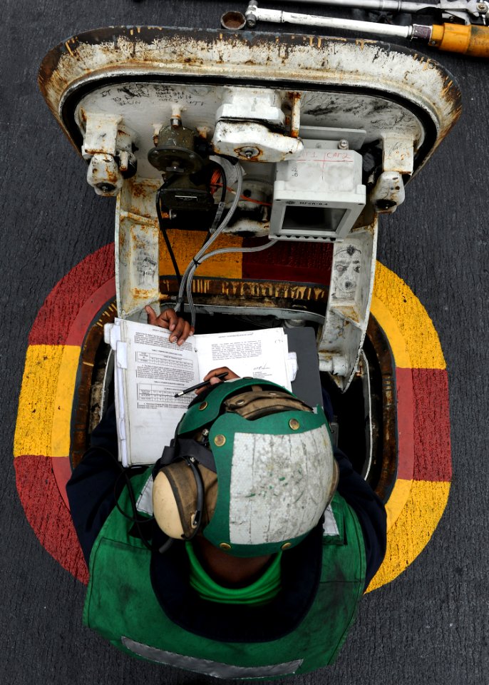 US Navy 100807-N-2821G-347 Aviation Boatswain's Mate (Equipment) Airman Eddie Harris, from Shreveport, La., the center deck operator, looks over the launching bulletin during flight operations aboard the aircraft carrier USS Ab