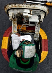 US Navy 100807-N-2821G-347 Aviation Boatswain's Mate (Equipment) Airman Eddie Harris, from Shreveport, La., the center deck operator, looks over the launching bulletin during flight operations aboard the aircraft carrier USS Ab