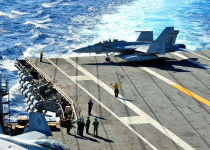 US Navy 100808-N-0569K-059 ircraft directors move an F-A-18F Super Hornet assigned to the Fighting Checkmates of Strike Fighter Squadron (VFA) 211