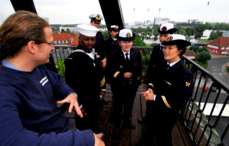 US Navy 100811-N-7638K-115 Samuel Attas explains the operation of the masting crane to Ship's Serviceman 1st Class Christopher Wint, second left, and sailors from the French and Italian navies during a historical tour of the Ho