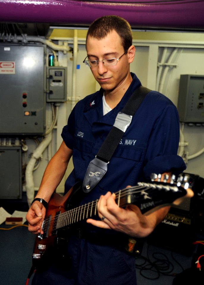 US Navy 100808-N-5838W-071 ogistics Specialist 3rd Class Joshua D. Lord plays guitar for Sailors aboard the aircraft carrier USS Enterprise (CVN 65)