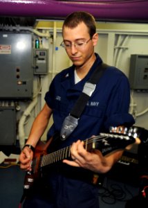 US Navy 100808-N-5838W-071 ogistics Specialist 3rd Class Joshua D. Lord plays guitar for Sailors aboard the aircraft carrier USS Enterprise (CVN 65)