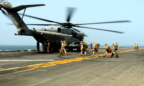 US Navy 100812-N-1226D-050 U.S. Marines board a Marine Corps CH-53E Super Stallion helicopter assigned to the White Knights of Helicopter Marine Medium (HMM) 165 aboard the amphibious assault ship USS Peleliu (LHA 5) photo