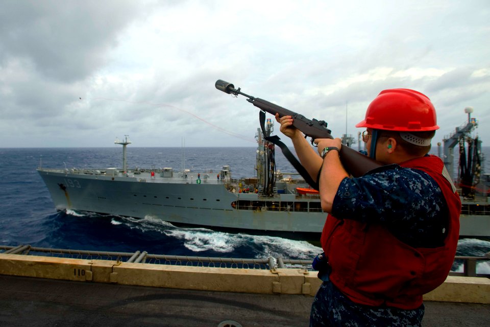 US Navy 100809-N-6720T-013 Gunner's Mate 2nd Class Paul Engoe, from Flint, Mich., uses an M-14 service rifle to fire a phone and distance line from the aircraft carrier USS George Washington (CVN 73) across the bow