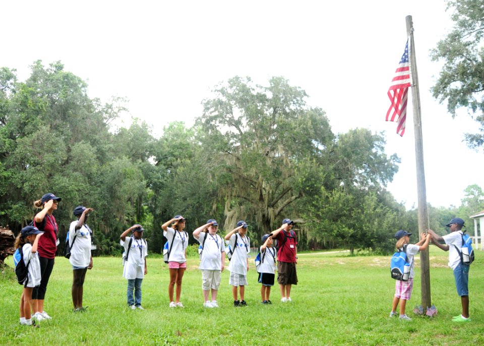 US Navy 100809-N-3013W-003 A team of Drug Education for Youth (DEFY) summer camp attendees from Naval Air Station Jacksonville and their mentors salute the national ensign during colors at Camp McConnell in Micanopy, Fla