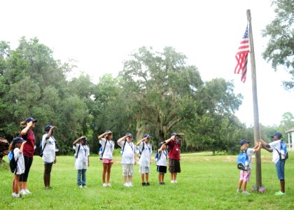 US Navy 100809-N-3013W-003 A team of Drug Education for Youth (DEFY) summer camp attendees from Naval Air Station Jacksonville and their mentors salute the national ensign during colors at Camp McConnell in Micanopy, Fla