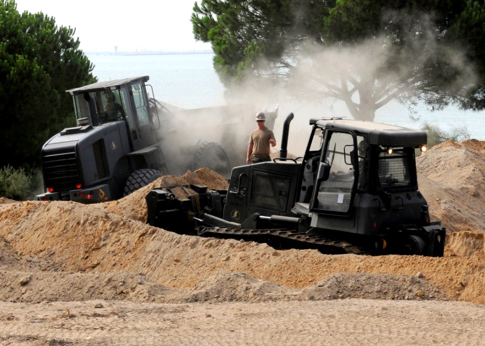 US Navy 100809-N-6357K-001 Seabees assigned to Naval Mobile Construction Battalion (NMCB) 7 excavate a project to extend an existing beach parking area at Naval Station Rota, Spain