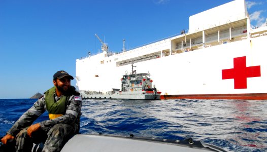 US Navy 100811-N-4044H-270 Royal Australian Navy Able Seaman Marine Technician Joey Mead operates a zodiac small boat as the Military Sealift Command hospital ship USNS Mercy (T-AH 19)