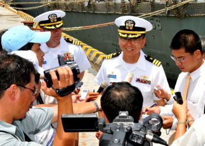 US Navy 100810-N-3215T-182 Cmdr. Jeffrey Kim speaks with Vietnamese reporters following the arrival of USS John S. McCain (DDG 56) to Da Nang, Vietnam