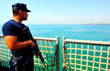 US Navy 100810-N-7948R-110 Logistics Specialist 3rd Class David Piadozo stands topside rover watch aboard the amphibious dock landing ship USS Pearl Harbor (LSD 52)