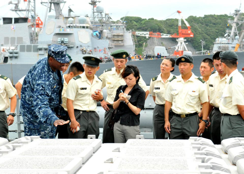 US Navy 100812-N-8113T-042 Lt. Bobby Jones describes the purpose and capabilities of the vertical launching system to a group of Japan Ground Self-Defense Force soldiers
