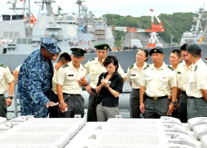 US Navy 100812-N-8113T-042 Lt. Bobby Jones describes the purpose and capabilities of the vertical launching system to a group of Japan Ground Self-Defense Force soldiers